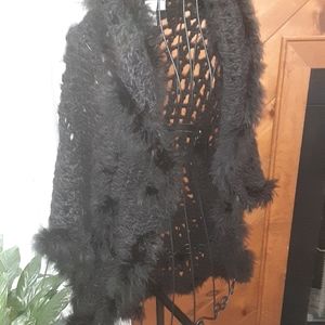 Beautiful black open knit sweater topper with fun and sexy feather trim.